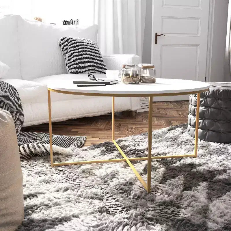 Table basse ronde moderne avec cadre en métal noir mat entrecroisé, plateau stratifié blanc